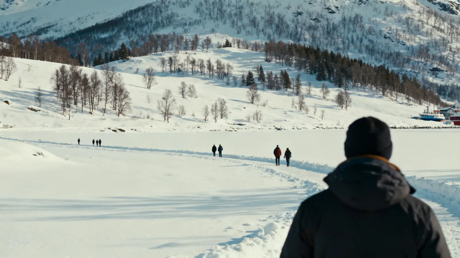A visitor facing a snow-covered landscape in daylight