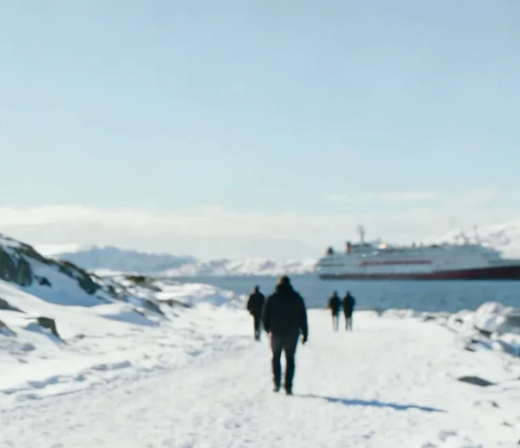 A passenger vessel beside a winter coast
